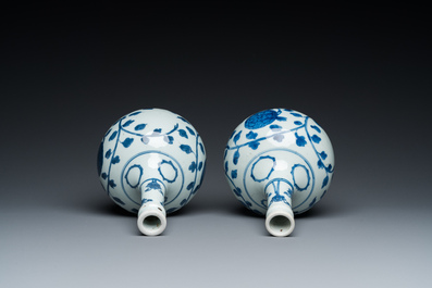 A pair of Chinese blue and white 'peony scroll' pharmacy bottles, Kangxi