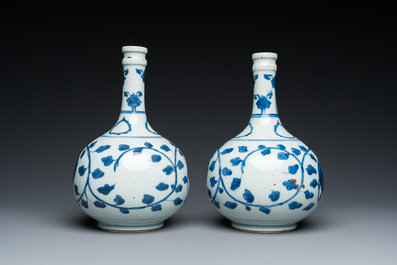 A pair of Chinese blue and white 'peony scroll' pharmacy bottles, Kangxi