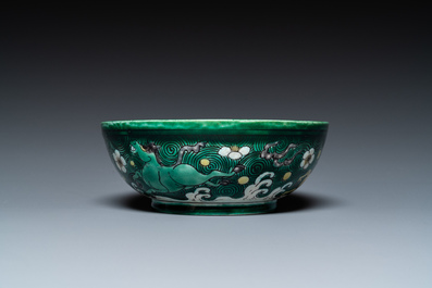 A Chinese verte biscuit 'galloping horses' bowl, Qing