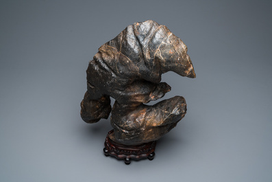 An exceptionally large Chinese 'gongshi' or 'scholar's rock' on wooden stand, probably Qing