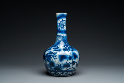 A Chinese blue and white 'dragons' bottle vase, 19th C.