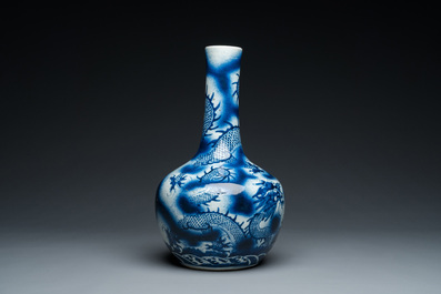 A Chinese blue and white 'dragons' bottle vase, 19th C.