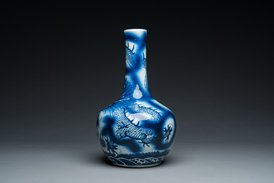A Chinese blue and white 'dragons' bottle vase, 19th C.
