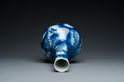 A Chinese blue and white 'dragons' bottle vase, 19th C.