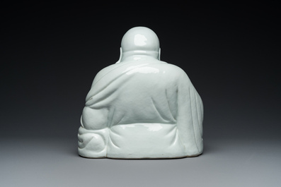 A Chinese blanc de Chine Buddha on lacquered and gilded wooden 'lotus' stand, Qianlong/Jiaqing