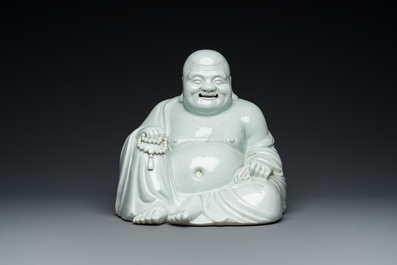 A Chinese blanc de Chine Buddha on lacquered and gilded wooden 'lotus' stand, Qianlong/Jiaqing