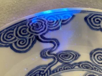 Two Chinese blue and white 'clouds' dishes and three plates, 19th C.