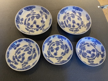 Two Chinese blue and white 'clouds' dishes and three plates, 19th C.