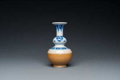 A Chinese blue and white double gourd vase with caf&eacute; au lait-ground base, Kangxi