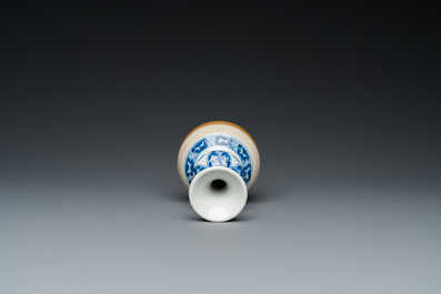 A Chinese blue and white double gourd vase with caf&eacute; au lait-ground base, Kangxi