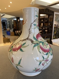 A Chinese famille rose 'nine peaches' bottle vase, 19th C.