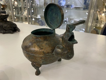 A Chinese gilt bronze tripod 'he' kettle with bird head-shaped spout, Han