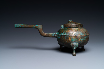 A Chinese gilt bronze tripod 'he' kettle with bird head-shaped spout, Han