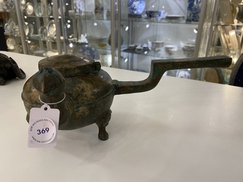 A Chinese gilt bronze tripod 'he' kettle with bird head-shaped spout, Han