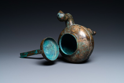 A Chinese gilt bronze tripod 'he' kettle with bird head-shaped spout, Han