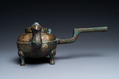 A Chinese gilt bronze tripod 'he' kettle with bird head-shaped spout, Han