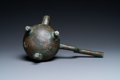 A Chinese gilt bronze tripod 'he' kettle with bird head-shaped spout, Han