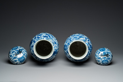A pair of Chinese blue and white covered vases with floral sprigs, 19th C.