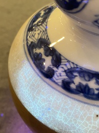 A Chinese blue and white double gourd vase with caf&eacute; au lait-ground base, Kangxi
