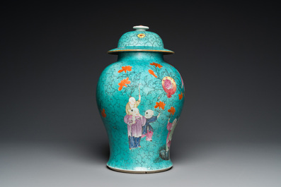 A Chinese turquoise-ground famille rose 'boys at a pomegranate tree' vase and cover, 19th C.