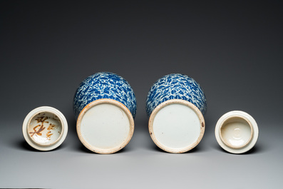 A pair of Chinese blue and white covered vases with floral sprigs, 19th C.