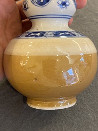 A Chinese blue and white double gourd vase with caf&eacute; au lait-ground base, Kangxi