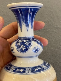 A Chinese blue and white double gourd vase with caf&eacute; au lait-ground base, Kangxi