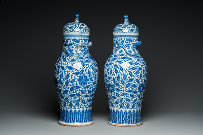 A pair of Chinese blue and white covered vases with floral sprigs, 19th C.