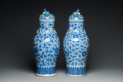 A pair of Chinese blue and white covered vases with floral sprigs, 19th C.