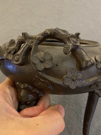 A Chinese bronze tripod censer and cover, 19th C.