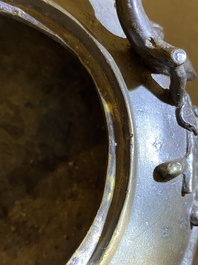 A Chinese bronze tripod censer and cover, 19th C.