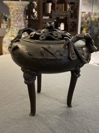 A Chinese bronze tripod censer and cover, 19th C.