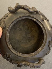 A Chinese bronze tripod censer and cover, 19th C.