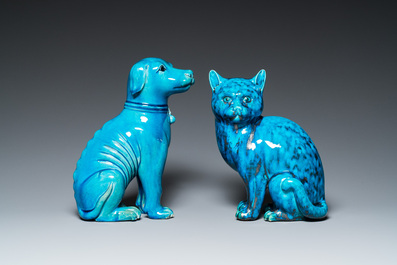 A Chinese turquoise-glazed cat and a dog on wooden stands, 19th C.