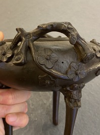 A Chinese bronze tripod censer and cover, 19th C.