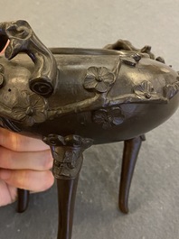 A Chinese bronze tripod censer and cover, 19th C.