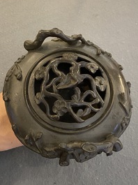 A Chinese bronze tripod censer and cover, 19th C.