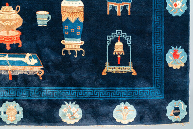A large Chinese blue-ground 'antiquities' rug, 19th C.