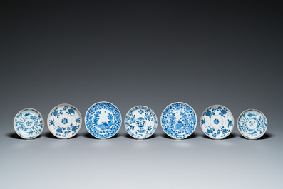 Eleven Chinese blue and white saucers, seven cups and a bowl, Kangxi/Qianlong