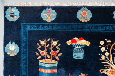 A large Chinese blue-ground 'antiquities' rug, 19th C.