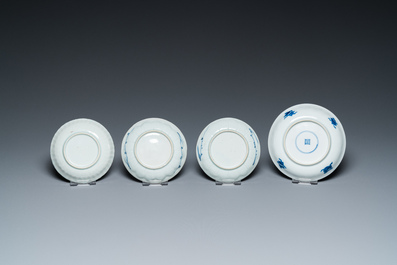 Eleven Chinese blue and white saucers, seven cups and a bowl, Kangxi/Qianlong