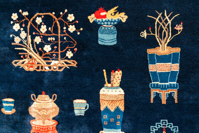 A large Chinese blue-ground 'antiquities' rug, 19th C.