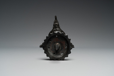 A large Chinese bronze reticulated candle holder, 17th C.