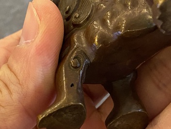 A Chinese bronze 'Buddhist lion' scroll weight, Qing