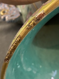 A pair of Chinese famille rose celadon-ground vases, 19th C.