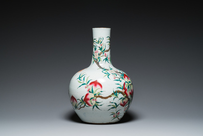 A Chinese famille rose 'nine peaches' bottle vase, Qianlong mark, 19th C.