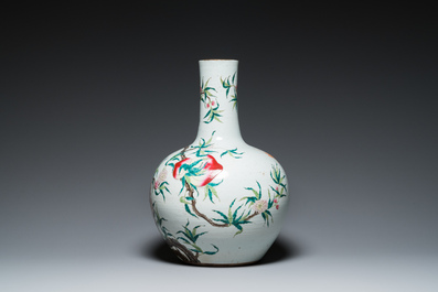 A Chinese famille rose 'nine peaches' bottle vase, Qianlong mark, 19th C.