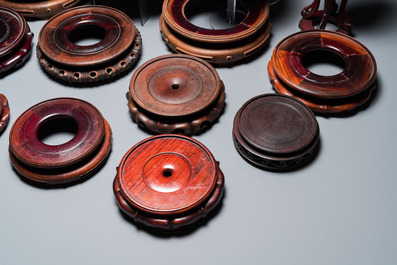 20 Chinese wooden stands and two reticulated covers, 19/20th C.