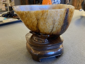 A Chinese hollowed jade libation cup on wooden stand, probably Qing