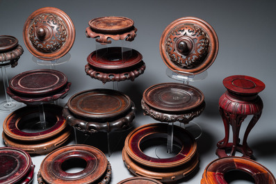 20 Chinese wooden stands and two reticulated covers, 19/20th C.